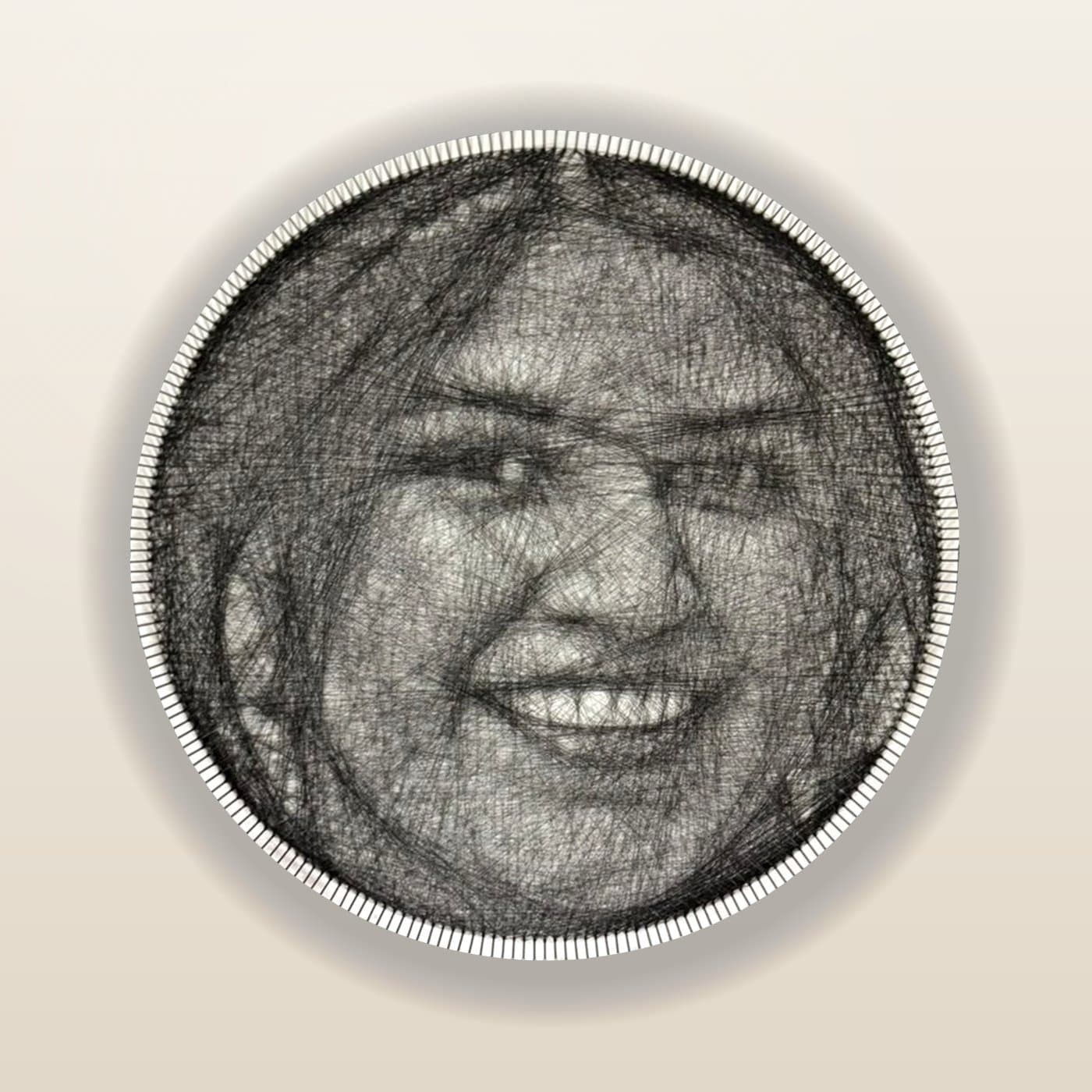 A hand-threaded 24-inch string-art portrait of a smiling woman